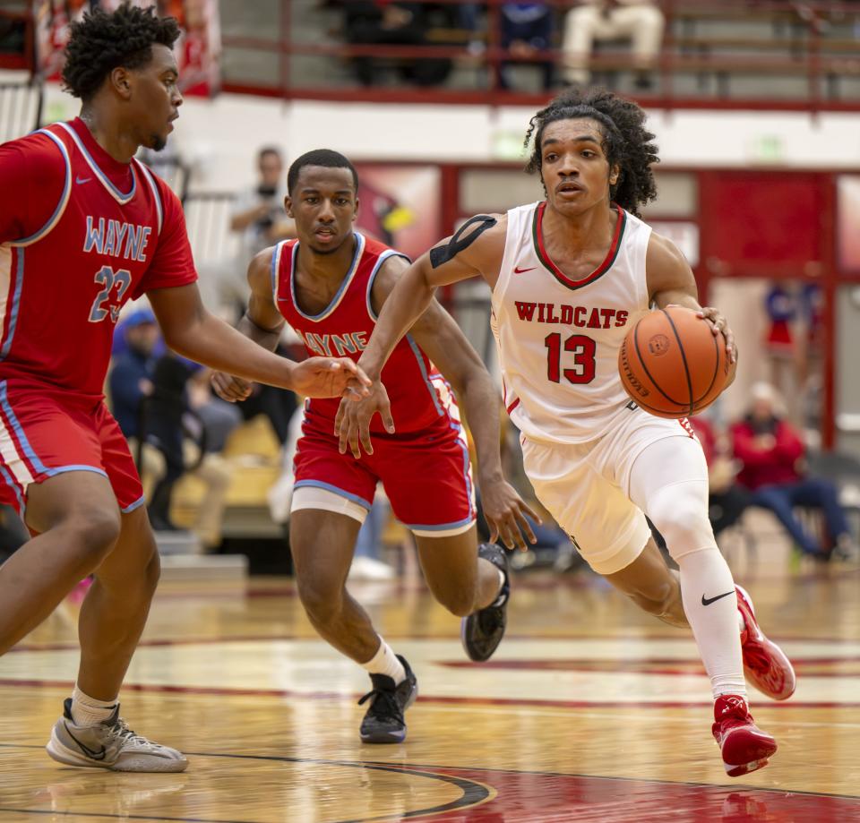 Lawrence North High School senior Kobi Bowles (13) races the ball up court and into the Fort Wayne Wayne High School defense during the first half of a game in the Forum Tipoff Classic, Saturday, Dec. 9, 2023, at Southport High School.