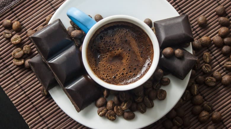 Top-down view of a mug of coffee with chocolate bars