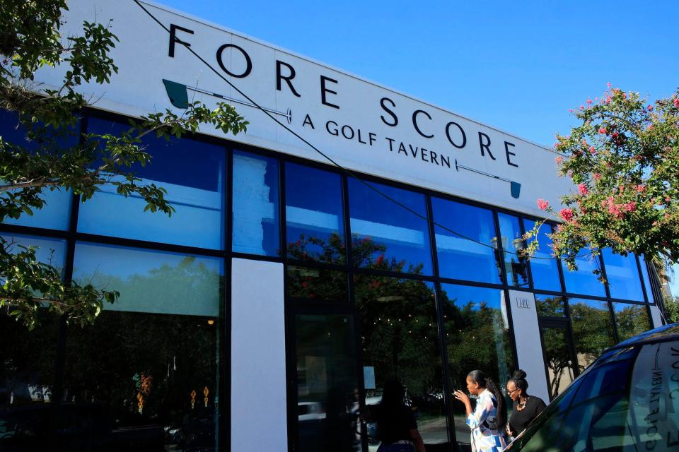 Patrons enter the newly opened Fore Score Golf Tavern at 1407 Atlantic Blvd. on historic San Marco Square in Jacksonville. The family-friendly restaurant offers four state-of-the-art golf simulators, food and a full-service bar. The simulators also offer other games and sports such as Zombie Dodgeball, football and soccer.