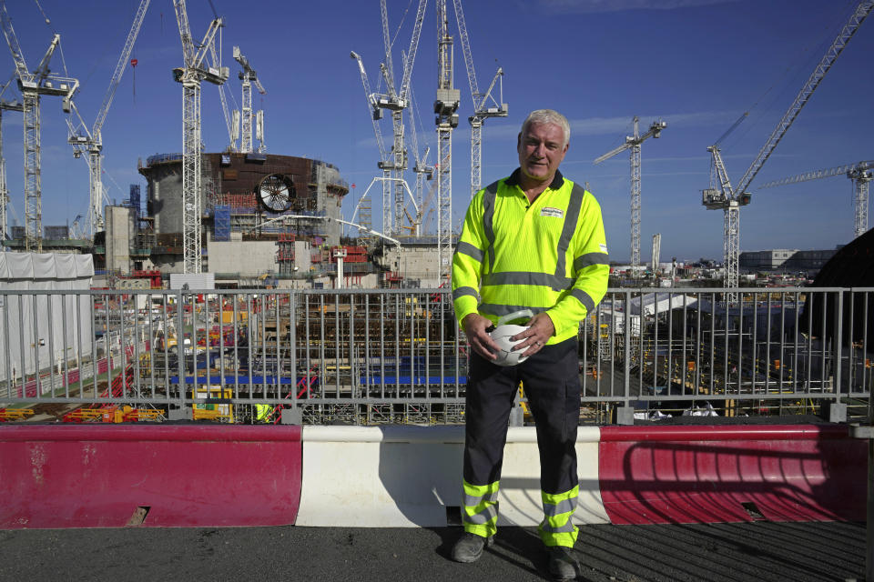Nigel Cann, project delivery director of Hinkley Point C, poses in front of the construction site of a nuclear reactor at Hinkley Point C nuclear power station in Somerset, England, Tuesday, Oct. 11, 2022. “We understand our responsibility to get this plant generating as quickly as possible," said Cann. “We feel that pressure, we feel the responsibility, but we will never compromise safety or quality.” (AP Photo/Kin Cheung)