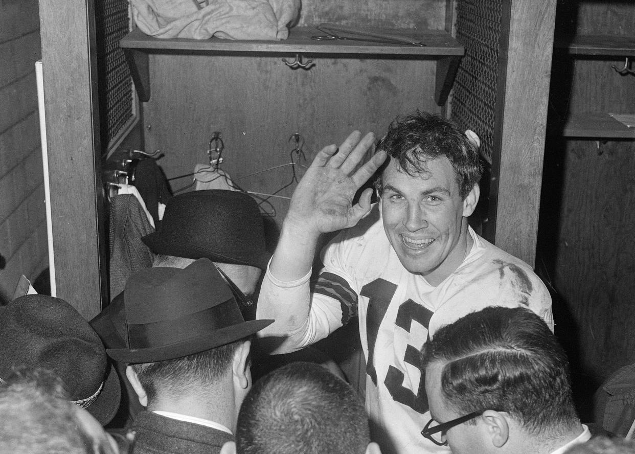 FILE - Cleveland Browns quarterback Frank Ryan gestures in the dressing room as he talks with reporters after the Browns defeated the Indianapolis Colts 27-0 in the NFL championship football game in Cleveland, Ohio, Dec. 27, 1964. Ryan, the quarterback who led the Cleveland Browns to their last NFL title in 1964, died Monday, Jan. 1, 2024. He was 87. (AP Photo/File)