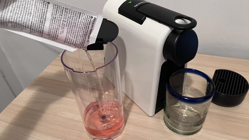 How to descale a Nespresso: Pour descaling solution 