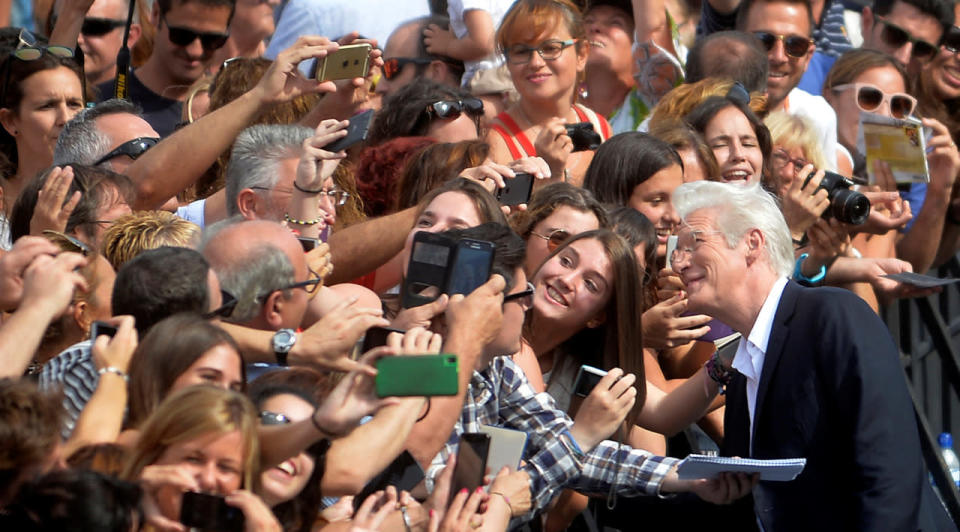 U.S. actor Richard Gere has his picture taken with fans