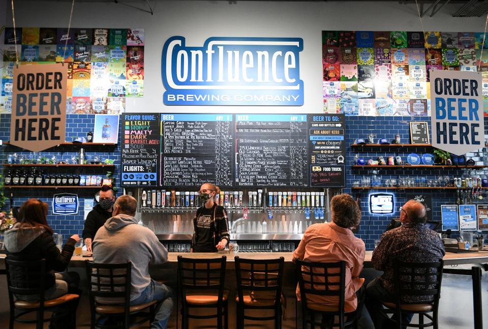 Confluence Brewing Co. lead bartender Samantha Spitler works the bar inside the taproom.