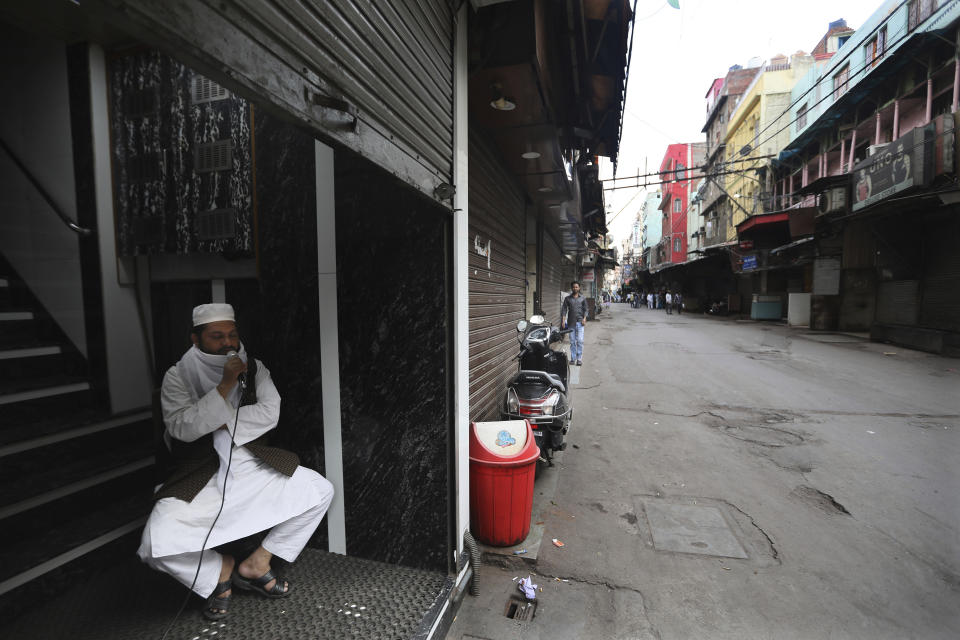 FILE - In this March 25, 2020, file photo, a Muslim priest asks people to take precautions against new coronavirus and remain inside their house during a lockdown to control the spread of the coronavirus, in New Delhi, India. Muslims in India are being stigmatized after the government blamed an Islamic missionary meeting for a surge in coronavirus cases. Experts who have studied previous epidemics warn that the stigma could hamper efforts to stop the contagion and prevent many from getting themselves tested. (AP Photo/Manish Swarup, File)