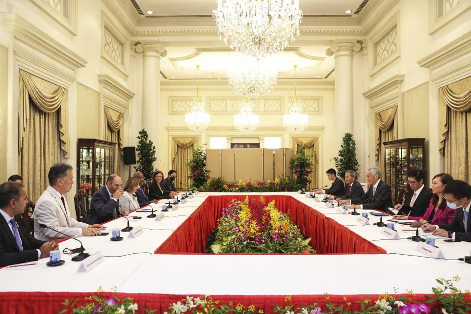 In this photo provided by Ministry of Communications and Information, Singapore, U.S. House Speaker Nancy Pelosi, fourth from left, and Prime Minister Lee Hsien Loong, fourth from right, meet at the Istana Presidential Palace in Singapore, Monday, Aug. 1, 2022. Pelosi arrived in Singapore early Monday, kicking off her Asian tour as questions swirled over a possible stop in Taiwan that has fueled tension with Beijing. (Ministry of Communications and Information, Singapore via AP)