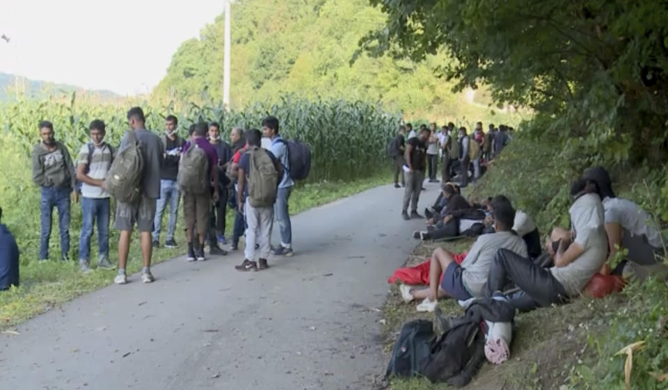 In this grab taken from video migrants who were directed off a railroad by police blocking the path gather, in Bosanska Otoka, Bosnia, Monday, Aug. 24, 2020. Bosnia’s quarreling ethnic leaders have put migrants amassed in the country while seeking entry to Europe at the center of a a political tug-of-war. Local authorities in the northwestern Krajina region have set up roadblocks to prevent migrants from entering the area under their jurisdiction, leaving hundreds trapped on the side of a road without access to food or shelter. (AP)