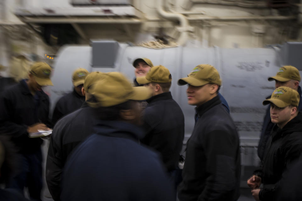 Sailors gather for a work party on board the USS Bataan on Monday, March 20, 2023 at Naval Station Norfolk in Norfolk, Va. Sailor work schedules can easily can be 12 hours or longer on a given day. (AP Photo/John C. Clark)