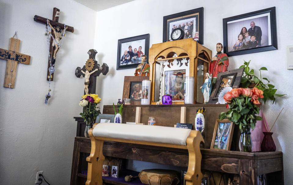 An altar dedicated to San Lorenzo, or Saint Lawrence, is displayed in the home of Barbara Finley, in Bernalillo, New Mexico, Monday, April 17, 2023. "For more than 300 years, Catholic faithful in this small town on the outskirts of Albuquerque have kept a special vow to St. Lawrence that includes one family each year setting up an altar for him in their home – and making it available 24/7 to anyone who wants to come pray. (AP Photo/Roberto E. Rosales)