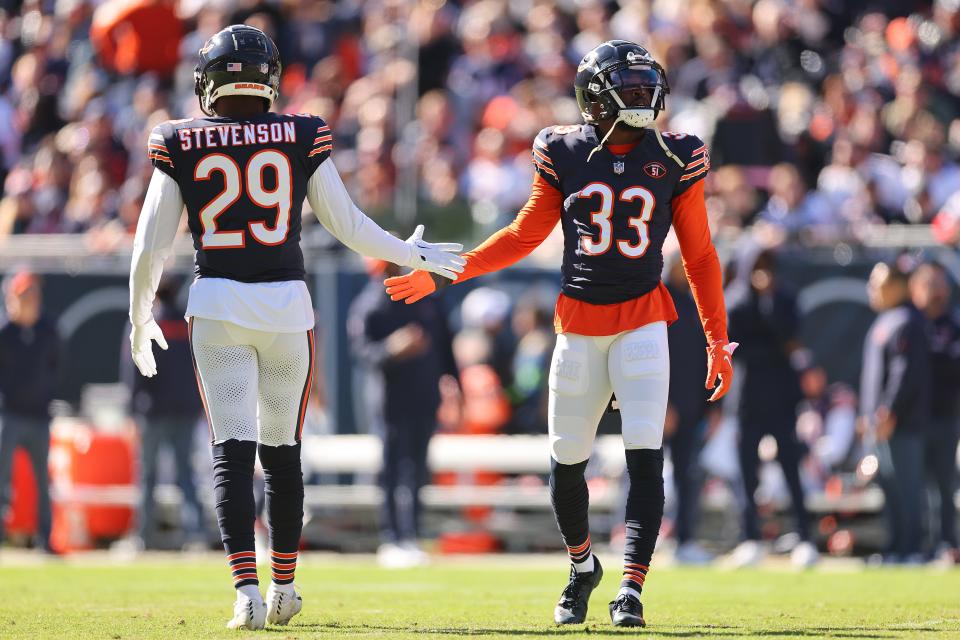 CHICAGO, ILLINOIS - OCTOBER 22: Tyrique Stevenson #29 and Jaylon Johnson #33 of the Chicago Bears celebrate a third down stop against the Las Vegas Raiders at Soldier Field on October 22, 2023 in Chicago, Illinois. (Photo by Michael Reaves/Getty Images)