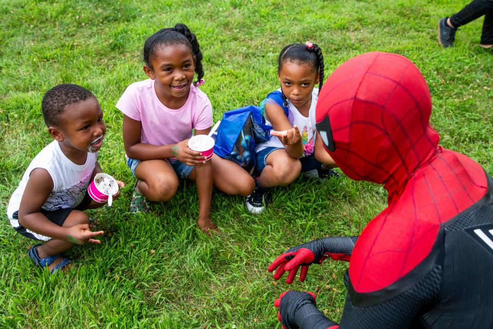 J'Merrion Morning, 3, Queenie Burrage, 7, and Golden Burrage, 5, meet with Spider-Man during the Salvation Army's second annual "Christmas in July" event at Evelyn Davis Park  Saturday, July 16, 2022 in Des Moines. The free event offered Iowans family-friendly summertime activities while simultaneously spreading awareness about mortgage, rent, utilities and food assistance through the Salvation Army's social services and Pathway of Hope programs.