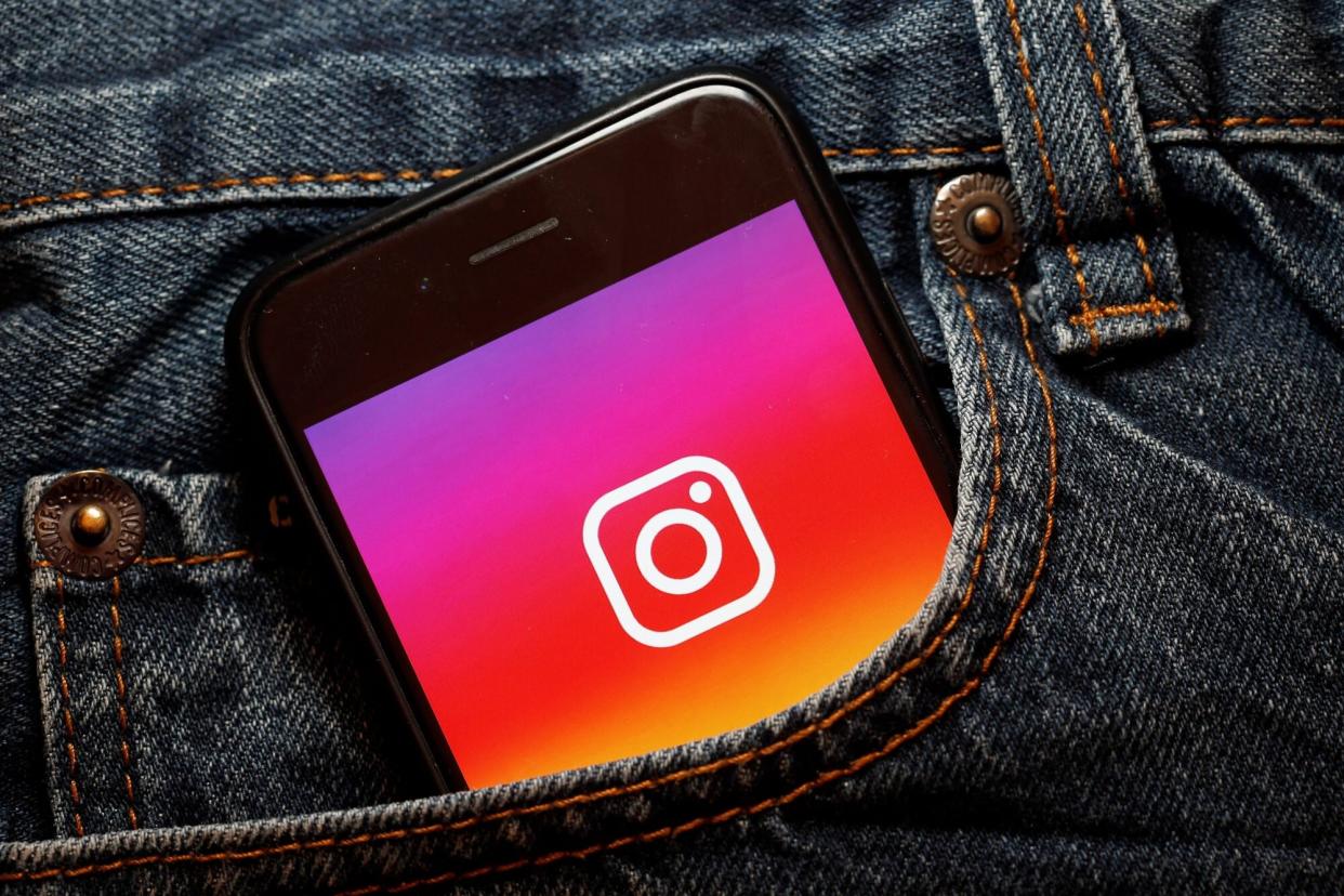 An image of a phone with the Instagram logo on it in a pocket.