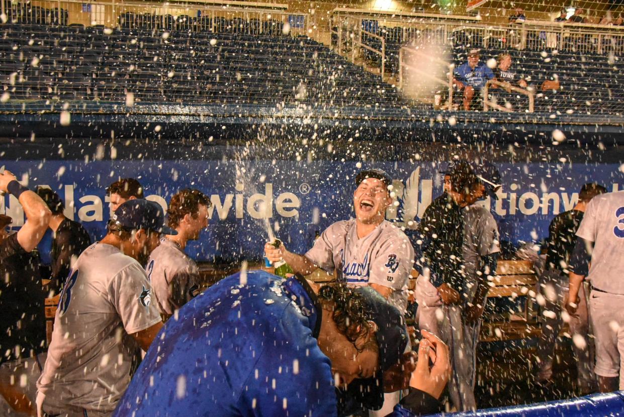 The Blue Wahoos celebrate in the visitors dugout June 23 after their 10-6 victory against the Biloxi Shuckers in Biloxi Miss. to clinch the first half Southern League South Division race and gain playoff spot for the league playoffs in September.