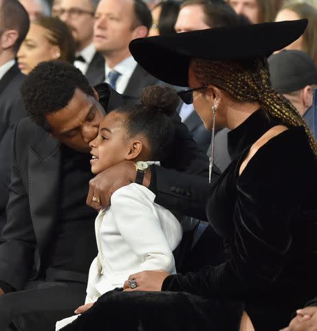 <p>Lester Cohen/Getty</p> Blue Ivy Carter at the 2018 Grammys with Beyoncé and JAY-Z