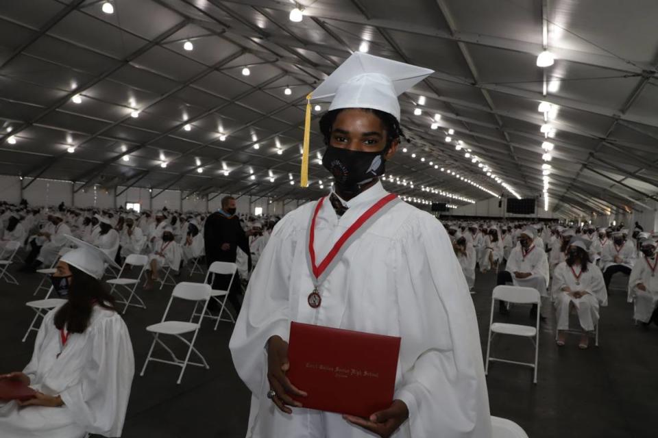 A Coral Gables Senior High graduate proudly displays his diploma Tuesday, June 1, 2021, at the school’s 2021 graduation ceremony at the Miami-Dade Fair & Expo, 10901 Coral Way. Due to the COVID-19 pandemic, students had to wear masks, were socially distanced in front of the stage and were limited to two tickets for guests.