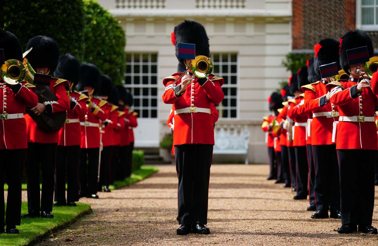 LONDON, ENGLAND - JULY 6: The Band of the Coldstream Guards play 'Three Lions' and 'Sweet Caroline' in the gardens of Clarence House ahead of England's Euro 2020 semi-final game against Denmark on July 6, 2021 in in London, England. In support to the England Football Team as they approach their Semi-Final match in the UEFA Euro Championships on Wednesday evening The Prince of Wales and The Duchess of Cornwall invited the Band of the Coldstream Guards into the Clarence House Garden to play the following pieces: Three Lions – Composed by Ian Broudie, arranged by Oliver Jeans and Sweet Caroline – Composed by Neil Diamond, arranged by Tim Waters.  (Photo by Victoria Jones-WPA Pool/Getty Images)