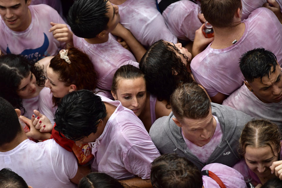 Revelers fill the town hall square celebrating the launch of the 'Chupinazo' rocket, to mark the official opening of the 2022 San Fermin fiestas in Pamplona, Spain, Wednesday, July 6, 2022. The blast of a traditional firework opened Wednesday nine days of uninterrupted partying in Pamplona's famed running-of-the-bulls festival which was suspended for the past two years because of the coronavirus pandemic. (AP Photo/Alvaro Barrientos)