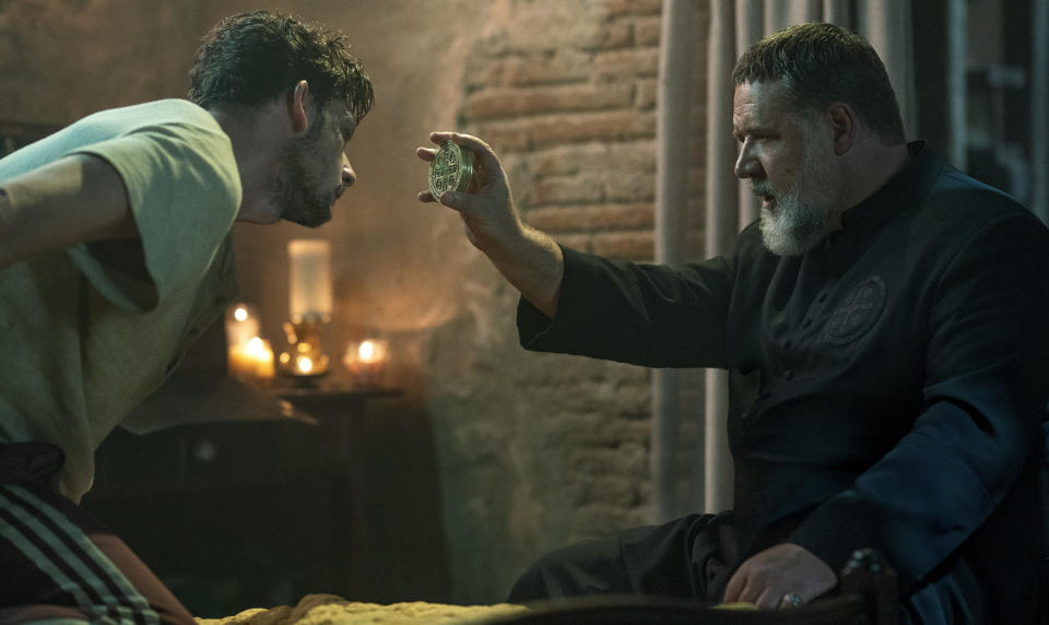 This image released by Sony Pictures shows Russell Crowe, right, in a scene from Screen Gems' "The Pope's Exorcist." (Jonathan Hession/Sony Pictures via AP)