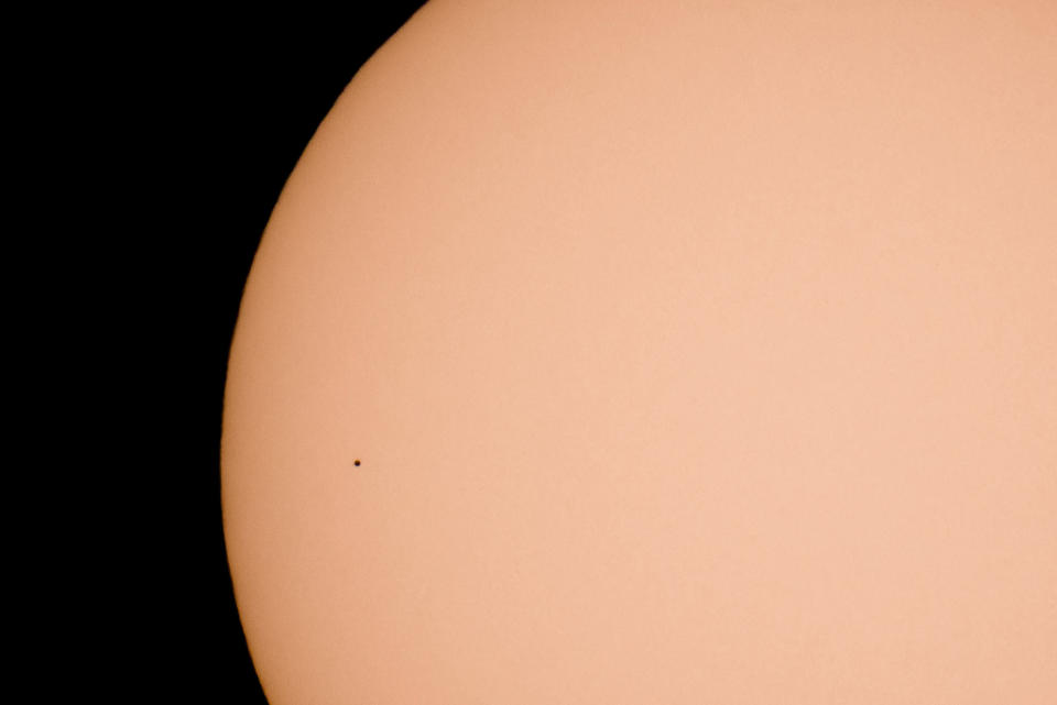 The planet Mercury transits across the face of the Sun, as seen from Kekesteto, Hungary's highest mountain peak, Monday, Nov. 11, 2019. Stargazers used solar filtered binoculars and telescopes to spot Mercury, the solar system's smallest, innermost planet, as a tiny black dot as it passed between Earth and the sun on Monday. (Peter Komka/MTI via AP)