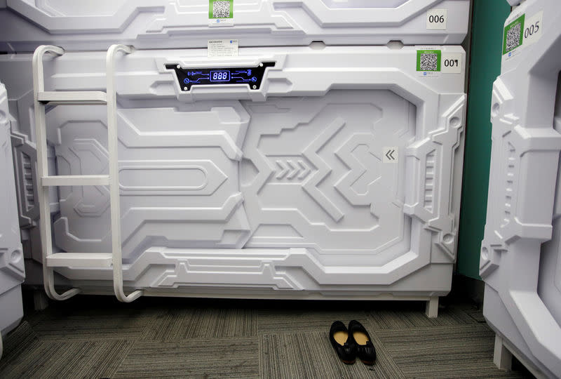 A woman's shoes are placed outside a capsule bed unit at Xiangshui Space during lunch break in Beijing's Zhongguancun area, China July 11, 2017. REUTERS/Jason Lee