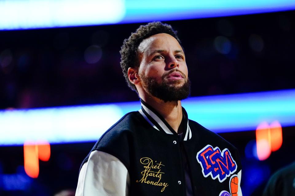 Golden State Warriors' Stephen Curry looks into the stands during the pre-game ceremony of an NBA basketball game against the New York Knicks Tuesday, Dec. 20, 2022, in New York. (AP Photo/Frank Franklin II)