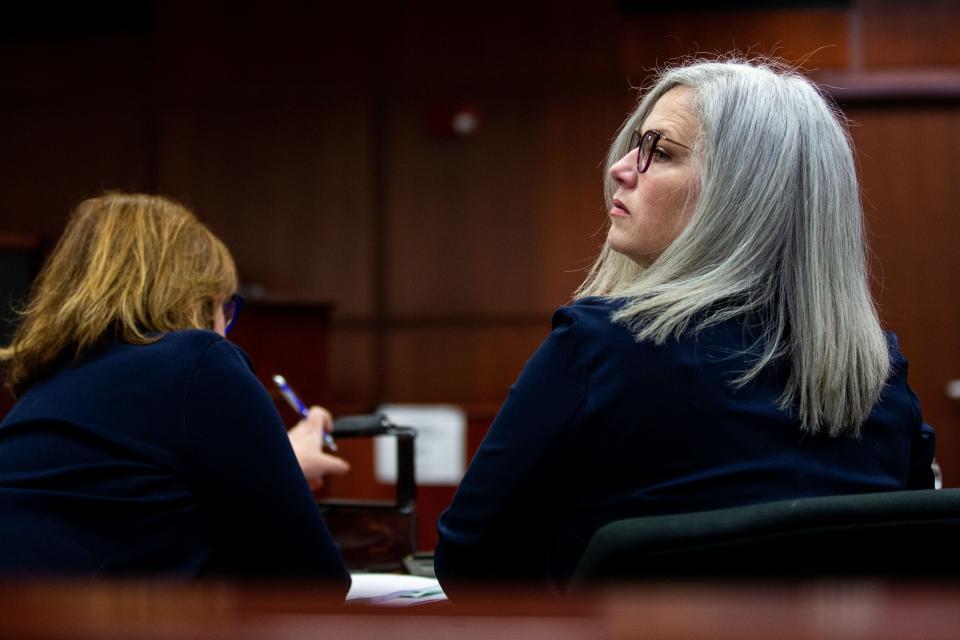 Ottawa County Health Officer Adeline Hambley looks over her shoulder as she takes her seat in the courtroom Friday, March 31, 2023, at the Michigan 14th Circuit court in Muskegon.