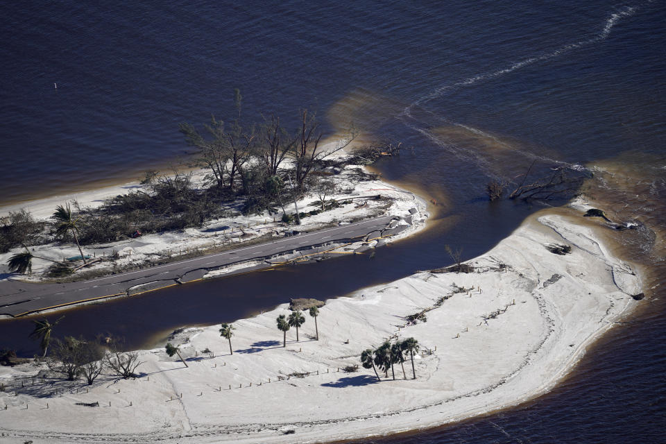 In this aerial photo made in a flight provided by mediccorps.org, damage from Hurricane Ian is seen on the causeway leading to Sanibel Island, making it impassable, in St. James City, Fla., on Pine Island, Friday, Sept. 30, 2022. (AP Photo/Gerald Herbert)