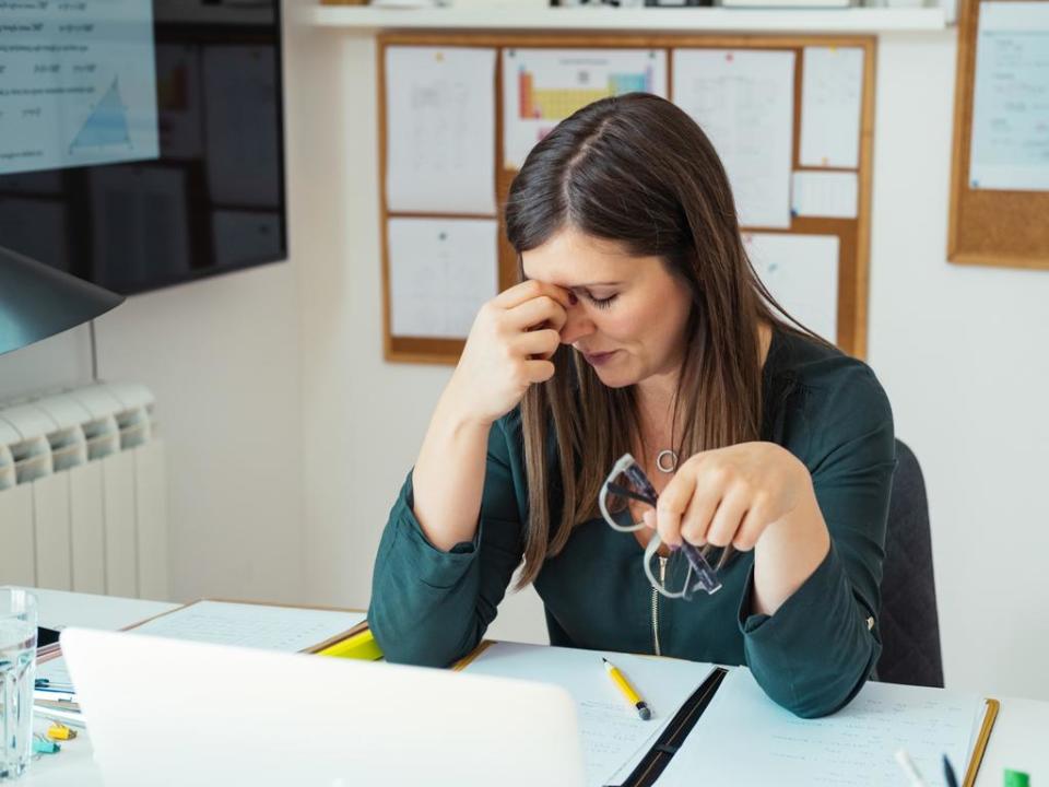 Young Tired Female Professor Having Headache