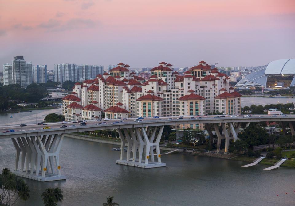 Elevated cityscape with highway bridge and apartment developments at dusk, Singapore, South East Asia