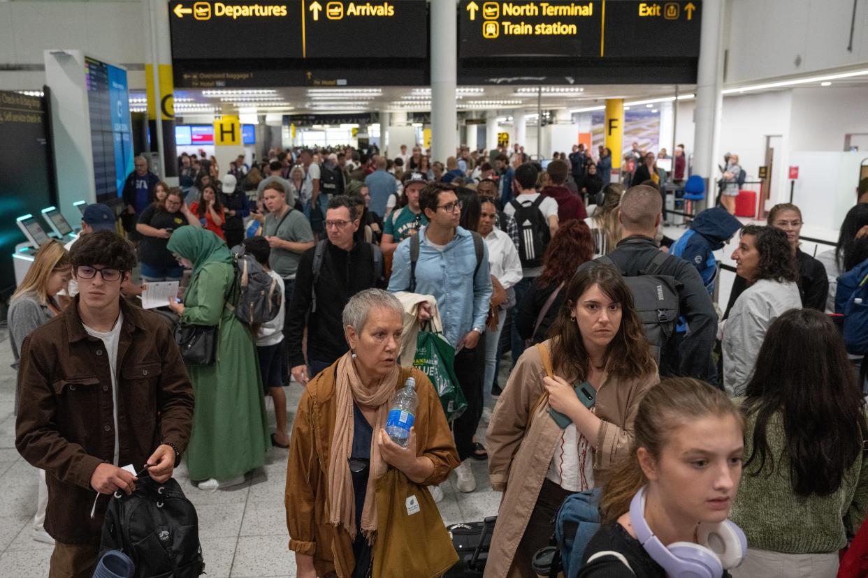 People wait near check-in desks at Gatwick Airport on 28 August 2023 in Crawley, United Kingdom (Getty Images)