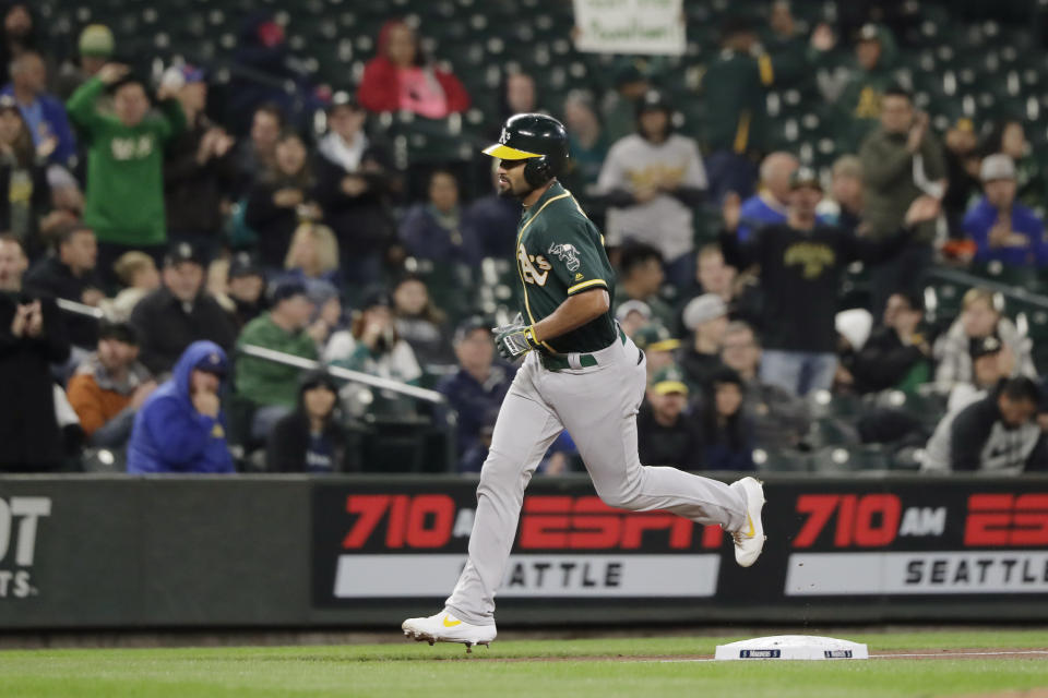 Oakland Athletics' Marcus Semien rounds the bases after hitting a solo home run during the first inning of a baseball game against the Seattle Mariners, Friday, Sept. 27, 2019, in Seattle. (AP Photo/Ted S. Warren)