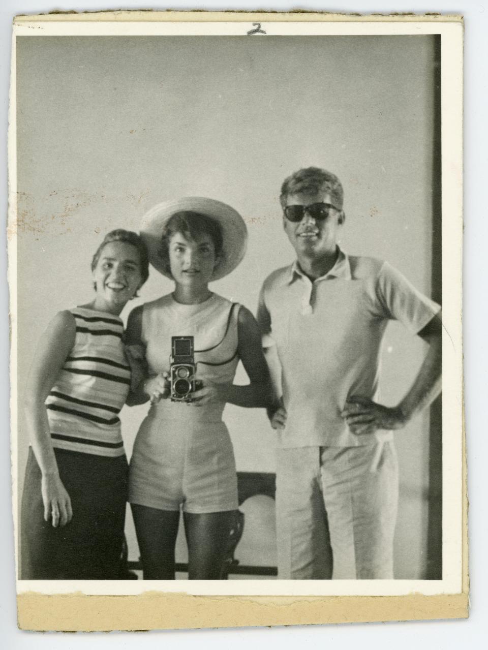 FILE - This undated file photo provided by John McInnis Auctioneers shows late President John F. Kennedy, right, with his wife, Jacqueline, center, and sister-in-law Ethyl Kennedy, left. The photograph is part of a collection of John F. Kennedy memorabilia from the family of David Powers, a former special assistant to the president, that fetched almost $2 million at auction Sunday, Feb. 17, 2013 at John McInnis Auctioneers in Amesbury, Mass. (AP Photo/John McInnis Auctioneers, File)