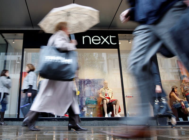 FILE PHOTO: Pedestrians walk past a Next shop in Oxford Street in London