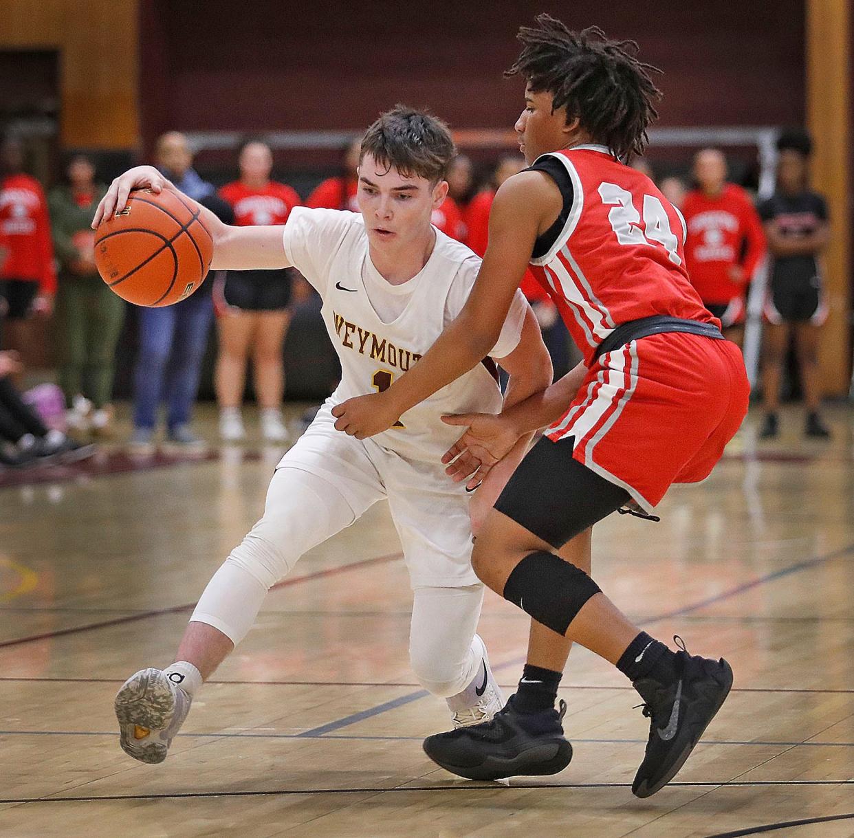 Gill Dolan works a move past CM guard Cory Dolison.Weymouth boys basketball hosts Catholic Memorial in a close game that had Weymouth lose by jus three points 68-71 on Friday December 9, 2022.