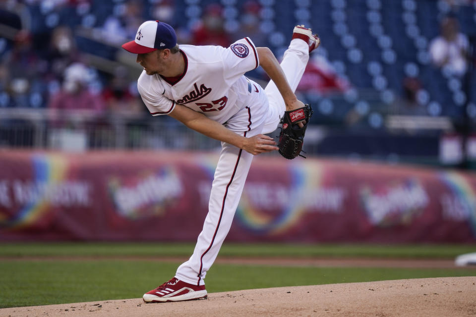 Washington Nationals starting pitcher Erick Fedde watches a throw during the first inning of the team's baseball game against the Atlanta Braves at Nationals Park, Wednesday, May 5, 2021, in Washington. (AP Photo/Alex Brandon)