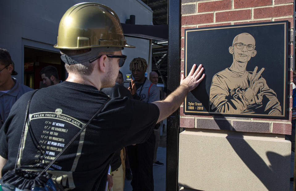 WEST LAFAYETTE, IN - SEPTEMBER 07: A Purdue Boilermakers student fan touches the plaque of Tyler Trent while entering the newly unveiled Tyler Trent Student Gate at Ross-Ade Stadium before the game against the Vanderbilt Commodores on September 7, 2019 in West Lafayette, Indiana. (Photo by Michael Hickey/Getty Images)