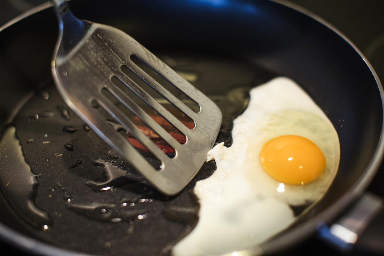 Turning eggs in a pan