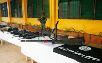 <p>A Philippine Marine guards the display of high-powered firearms, ammunitions, uniforms and black ISIS-style flags which were recovered from Muslim militants Tuesday, May 30, 2017 in Marawi city southern Philippines. Philippine forces pressed their offensive to drive out militants linked to the Islamic State group after days of fighting left corpses in the streets and hundreds of civilians begging for rescue from a besieged southern city of Marawi. (Bullit Marquez/AP) </p>