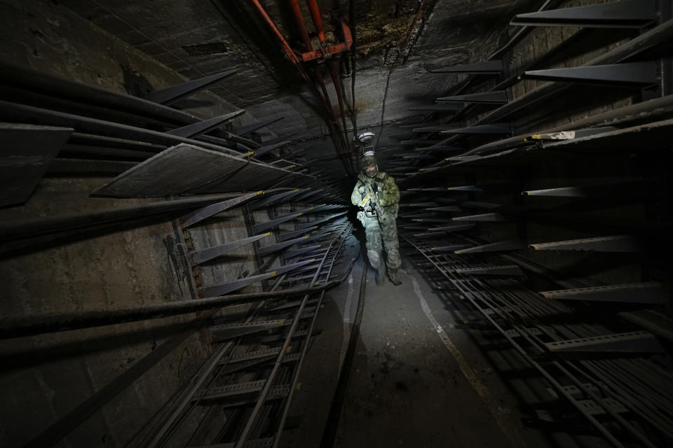 FILE - A Russian soldier inspects a corridor in the Azovstal steel mill in Mariupol, in territory under control of the government of the Donetsk People's Republic, in eastern Ukraine, Monday, June 13, 2022. This photo was taken during a trip organized by the Russian Ministry of Defense. (AP Photo/File)