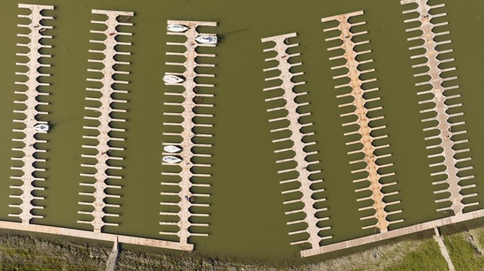 Docks float in the Browns Ravine Cove area of Folsom Lake in Folsom, Calif., on Sunday, March 26, 2023. Months of winter storms have replenished California’s key reservoirs after three years of punishing drought. (AP Photo/Josh Edelson)
