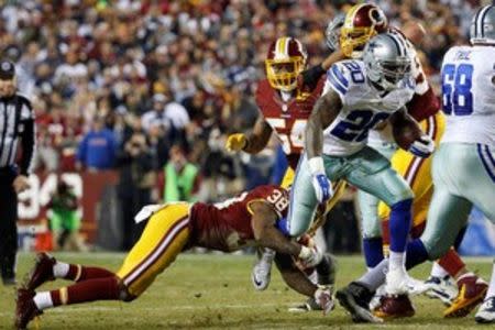 Dallas Cowboys running back Darren McFadden (20) carries the ball as Washington Redskins free safety Dashon Goldson (38) attempts the tackle in the second quarter at FedEx Field. The Cowboys won 19-16. Mandatory Credit: Geoff Burke-USA TODAY Sports