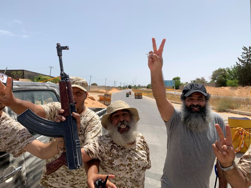 Fighters loyal to Libya's internationally recognised government celebrate after regaining control over Tripoli