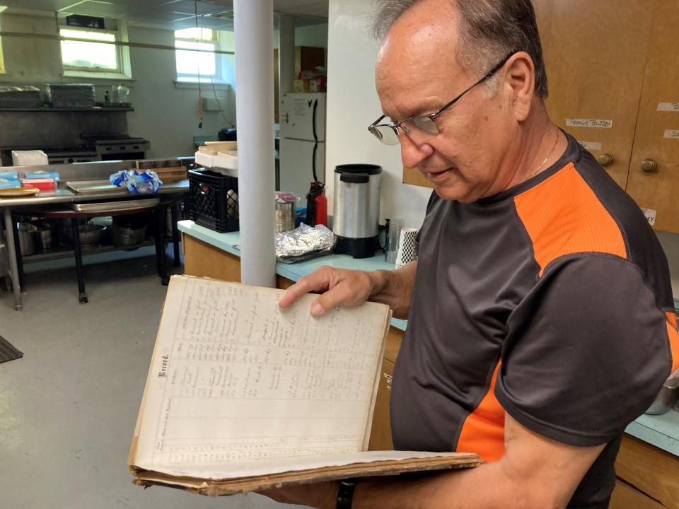 Bob Sarsfield of Summerfield United Methodist Church in Milwaukee looks at a book of marriage records dating to 1874. The church, located at North Cass Street and East Juneau Avenue, was constructed in 1904 as the successor to Summerfield’s first church.