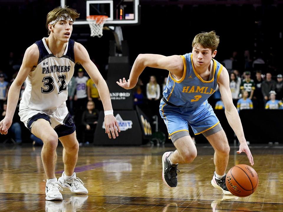 Hamlin's Easton Neuendorf dribbles against Dakota Valley's Randy Rosenquist during their semifinal game in the state Class A boys basketball tournament on Friday, March 17, 2023 in the Denny Sanford PREMIER Center at Sioux Falls.