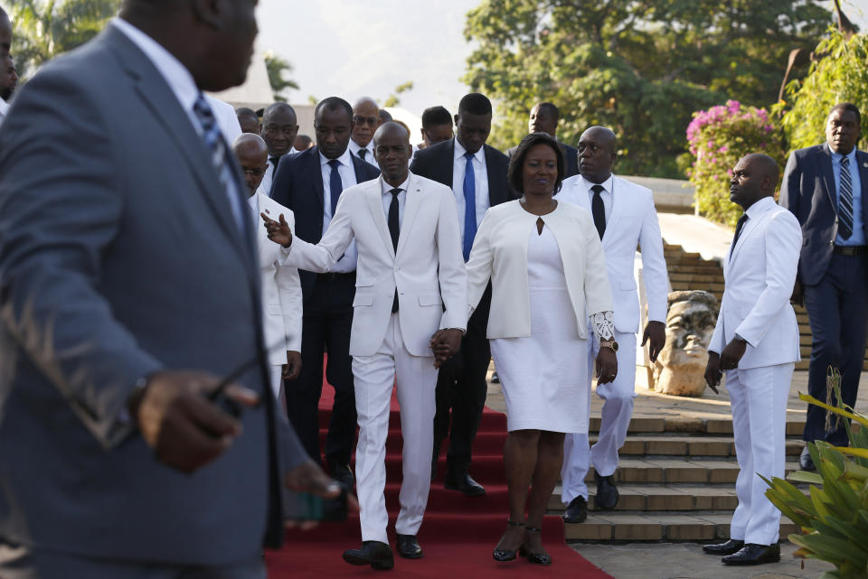 Accompanied by First Lady Martine Moise, center right, and and acting prime minister Jean Michel Lapin, center left, President Jovenel Moise, center, arrives to lay flowers to mark the anniversary of the death of Haitian revolution leader Jean Jacques Dessalines, at Champ de Mars, adjacent to the National Palace, in Port-au-Prince, Haiti, Thursday Oct. 17, 2019. President Moise has been facing ever more violent protests demanding his resignation fueled by anger over corruption, inflation and dwindling of basic supplies, including gasoline. (AP Photo/Rebecca Blackwell)