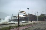 Waves break on a seaside tavern during a storm at the port of Argostoli, on the Ionian island of Kefalonia, western Greece, Friday, Sept. 18, 2020. A powerful tropical-like storm named Ianos battered the western islands of Zakynthos, Kefalonia, and Ithaki overnight, causing flash flooding, property damage, power outages, and road closures mostly from downed trees, police and local authorities said. (AP Photo/Nikiforos Stamenis)