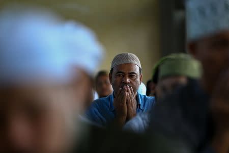 Muslims attend an Eid al-Fitr mass prayer to mark the end of the holy fasting month of Ramadan at a mosque in Bangkok, Thailand, June 25, 2017. REUTERS/Athit Perawongmetha