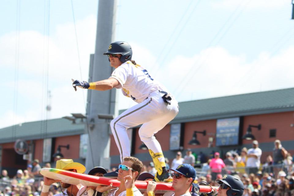 A player for the Savannah Bananas crowd surfs in a game against the Party Animals in 2023 at 121 Financial Ballpark in Jacksonville.