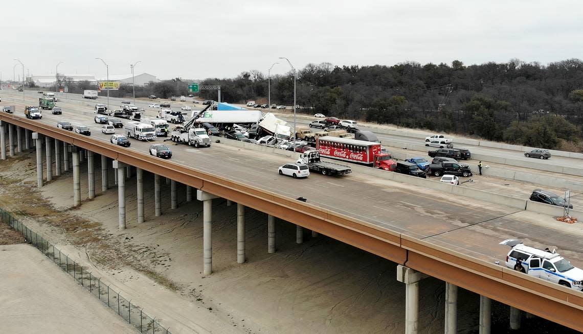 First responders work to remove vehicles involved in a massive pile-up that killed five people on I-35 near downtown Fort Worth on Thursday, February 11, 2021.