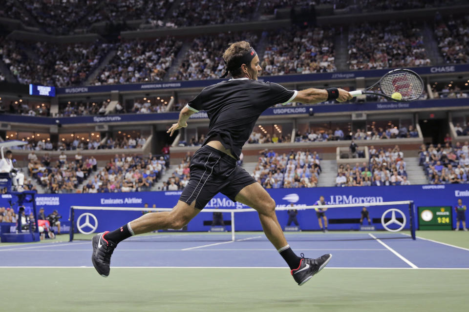 Roger Federer, of Switzerland, runs down a shot from Grigor Dimitrov, of Bulgaria, during the quarterfinals of the U.S. Open tennis tournament Tuesday, Sept. 3, 2019, in New York. (AP Photo/Seth Wenig)